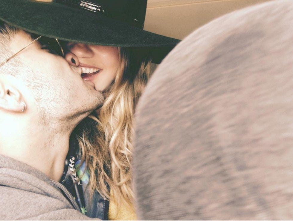 Love, Hat, Lip, Smile, Interaction, Eye, Cowboy hat, Headgear, Fun, Kiss, 