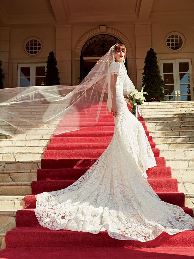 Shoulder, Bridal clothing, Textile, Dress, Red, Gown, Petal, Formal wear, Wedding dress, Flooring, 