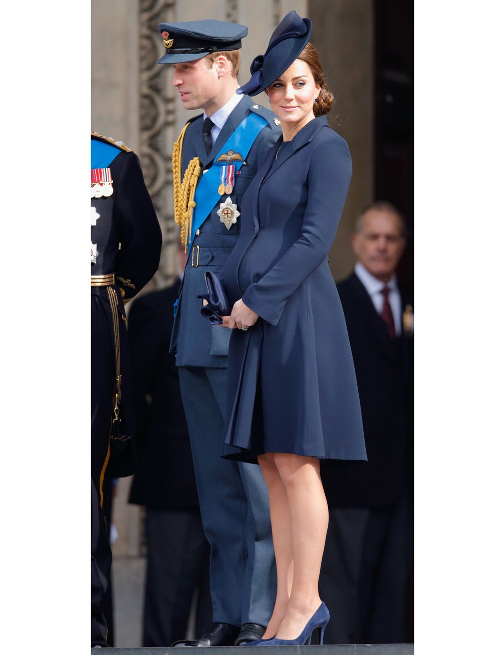 Clothing, Uniform, Academic dress, Trench coat, Standing, Fashion, Coat, Electric blue, Outerwear, Street fashion, 