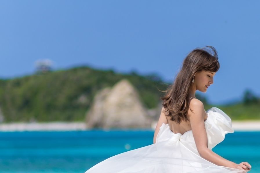 Clothing, Blue, Hairstyle, Shoulder, Textile, Photograph, Bridal clothing, Dress, Coastal and oceanic landforms, Wedding dress, 