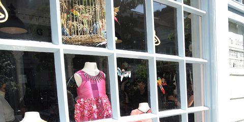 Mannequin, Retail, Pattern, One-piece garment, Display window, Peach, Day dress, Fashion design, Boutique, Display case, 