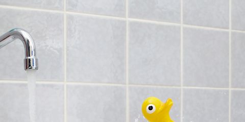 Fluid, rubber ducky, Bath toy, Liquid, Wall, Plumbing fixture, Tile, Toy, Ducks, geese and swans, Aqua, 