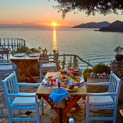 Furniture, Table, Sunset, Outdoor furniture, Coastal and oceanic landforms, Chair, Outdoor table, Sunrise, Dusk, Restaurant, 