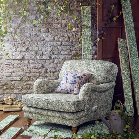 Furniture, Wall, Armrest, Stone wall, Club chair, Outdoor furniture, Couch, Outdoor sofa, Pillow, Throw pillow, 