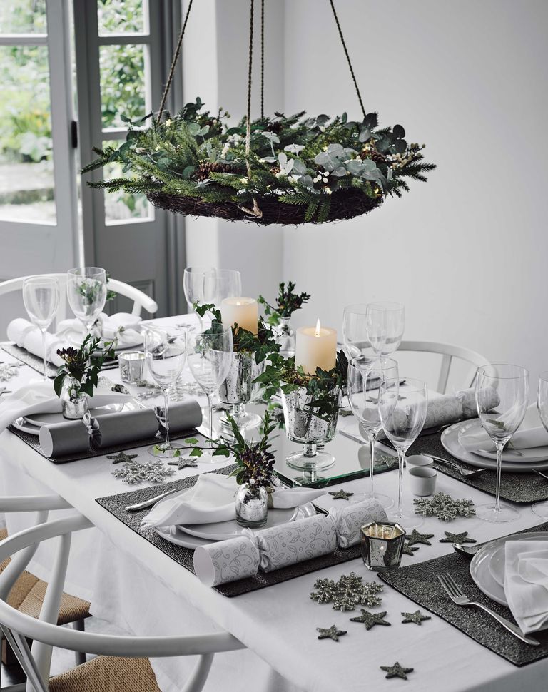 Horizontal wreath above table set for Christmas dinner