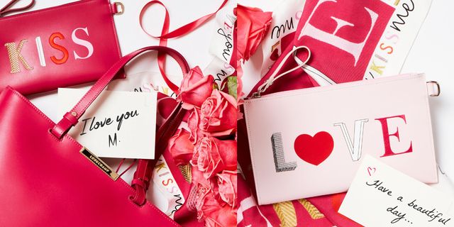 Red, Ribbon, Font, Carmine, Present, Heart, Paper product, Party favor, Gift wrapping, Confectionery, 