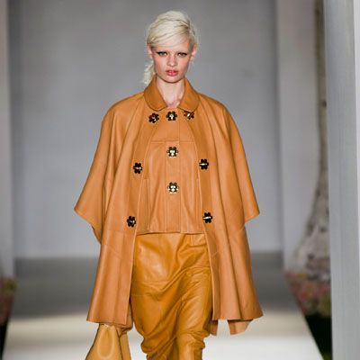 Brown, Sleeve, Human body, Fashion show, Textile, Joint, Outerwear, Style, Fashion model, Runway, 