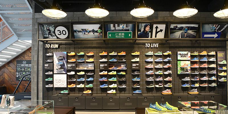 Retail, Light fixture, Athletic shoe, Collection, Shoe store, Shelf, Outdoor shoe, Advertising, Trade, Display case, 