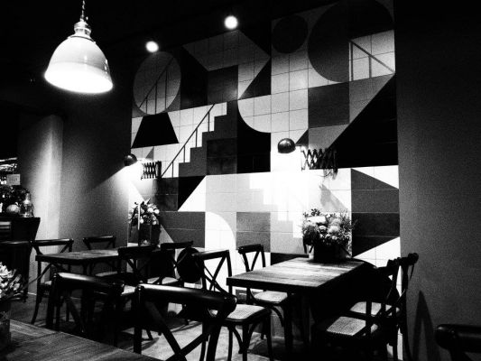 Room, Table, Furniture, Interior design, Light fixture, Restaurant, Monochrome photography, Ceiling fixture, Kitchen & dining room table, Black-and-white, 
