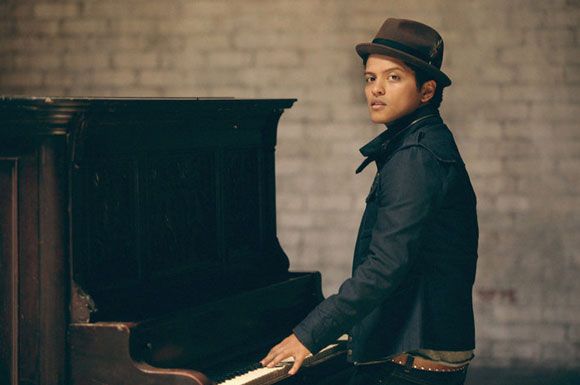 Pianist, Musician, Musical instrument accessory, Musical instrument, Hat, Jacket, Keyboard, Outerwear, Jazz pianist, Sitting, 