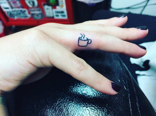 Finger, Wrist, Nail, Thumb, Tattoo, Symbol, Temporary tattoo, Handwriting, Cosmetics, Flesh, 