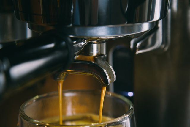 espresso being made and pouring into a cup