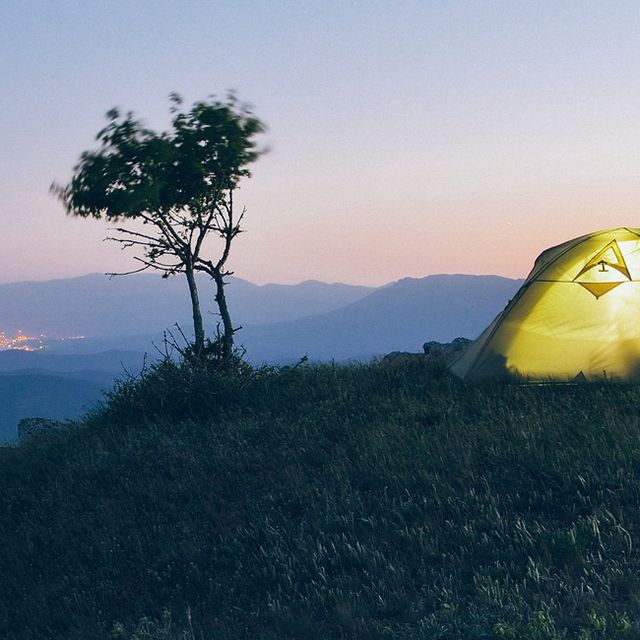 Night landscape with tourist tent. Camping in the mountains