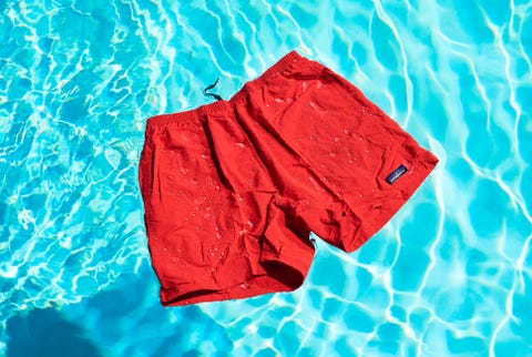 a pair of red shorts floating in a swimming pool