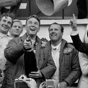 Dan Gurney, with bottle in hand, and A.J. Foyt celebrate their own win in a Ford GT40 at Le Mans in 1967.
