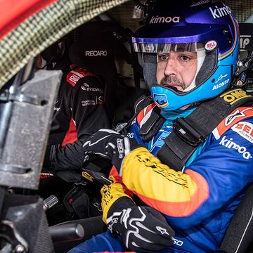 Fernando Alonso looks right at home in the cockpit of a Toyota Hilux rally truck.

