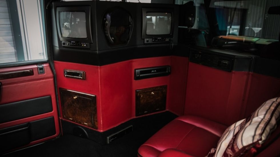 The interior appears designed to let the rear-seat passengers watch one TV set, while the middle-seat passenger watches another seat at the same time. Otherwise there would be just one TV that could rotate to face either seat, right?
