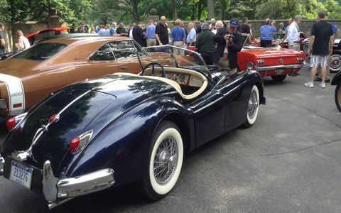 The 1955 Jaguar XK140 (foreground) was rescued from a rusty death in a field and restored. It was one of the first Jaguar models made with the American market in mind.