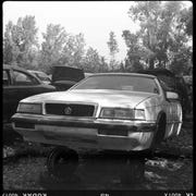 An Italianate Chrysler LeBaron in a Wisconsin wrecking yard, photographed with a 1940 Ansco Speedex film camera.