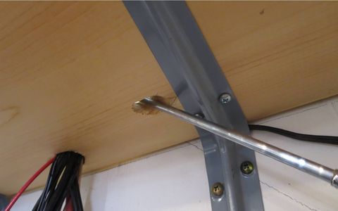 The "rabbit-ear" dual power antennas extend through slots in the shelf above.