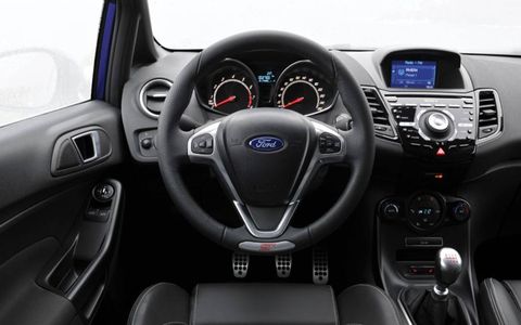 Sporty accents inside the 2014 Ford Fiesta ST include a leather-wrapped steering wheel and shift knob.