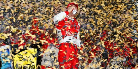 Kevin Harvick enjoys a Budweiser in a sea of confetti at Kansas Speedway after his win on Sunday.