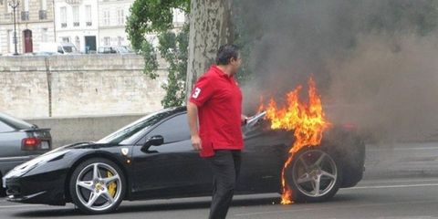 This photo of a Ferrari 458 Italia owner walking away from his burning car in Paris has been posted on several Internet sites.
