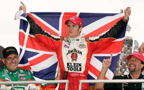 Dan Wheldon flies the Union Jack after winning the Indianapolis 500 in 2005 with team owners Kim Green and Michael Andretti.