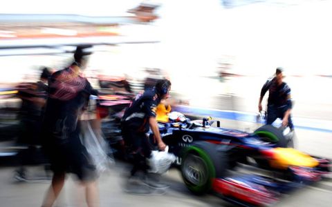 MEN IN MOTION // Sebastian Vettel&#8217;s Red Bull RB8 Renault  arrives outside the garage prior to the first practice for the Korean Grand Prix at the Korea International Circuit in Yeongam-Gun, South Korea. Photo by LAT Photographic