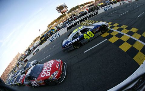 Tony Stewart and Jimmie Johnson go side-by-side down the front strecth at Martinsville Speedway in Martinsville, Va., on Oct. 30. Photo by: LAT Photographic