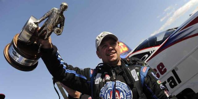 NHRA Funny Car driver Robert Hight holds the trophy after his win in Las Vegas on Sunday.