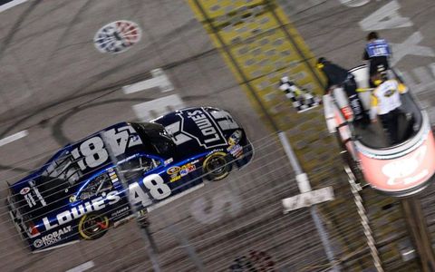 Jimmie Johnson takes the checkered flag at Texas Motor Speedway on Sunday.