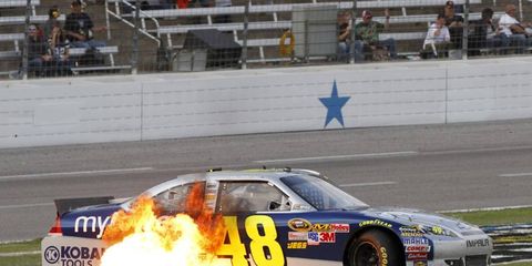 Flame Throwing // Jimmie Johnson&#8217;s car shoots fire as he restarts the engine at Texas Motor Speedway on Nov. 6. Photo by: Lesley Ann Miller/LAT Photographic