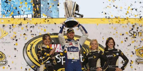 Jimmie Johnson holds the championship trophy.