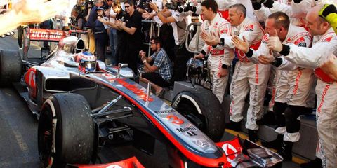 Jenson Button greets his crew after his win on Saturday night.