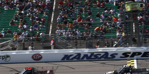 James Buescher passed Tim Peters and then held out to win the Camping World Truck Series race in Kansas on Saturday.