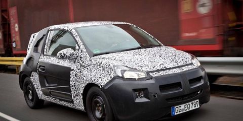 A photo released by Opel shows a camouflaged three-door hatchback.