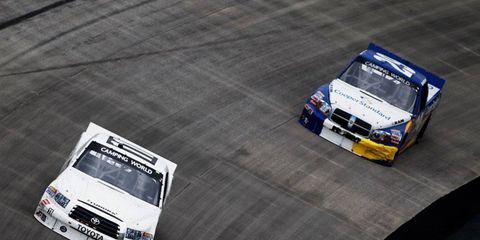 Todd Bodine leads Parker Kligerman during the Lucas Oil Camping World Truck Series 200 at Dover International Speedway on Friday.