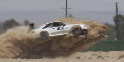 The No. 25 Ford Mustang of Steve Butscher takes flight after hitting a dirt berm.