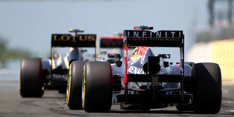 Romain Grosjean speeds out in front of Sebastian Vettel. Grosjean rounded out the top three in Sunday's race in Hungary.