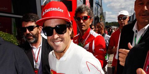 Winner Fernando Alonso makes his way from the track after winning the German Grand Prix on Sunday.