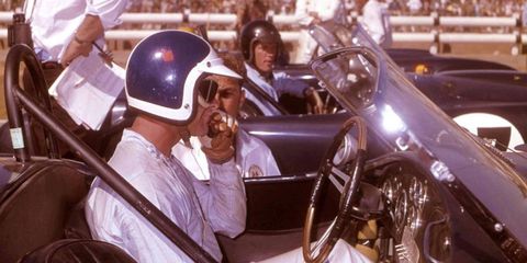 Bob Bondurant ponders his move into turn one as Dan Gurney casts a knowing eye on his rival.