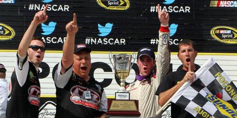 Chad Hackenbracht and crew celebrate at Pocono Raceway on Saturday after Hackenbracht notched his first career win in the series.