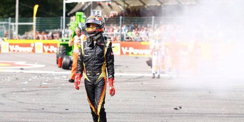 Romain Grosjean walks away from the crash scene at Spa in Belgium on Sunday.