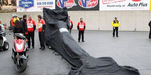 Doug Kalitta's Top Fuel dragster was under a tarp on Sunday. Kalitta did advance to the second round before rain washed out the rest of the day.