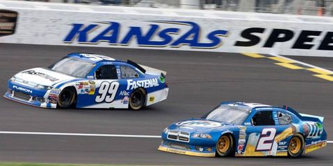NASCAR Sprint Cup Series points leader Brad Keselowski (2) battles Carl Edwards for track position at Kansas on Sunday.