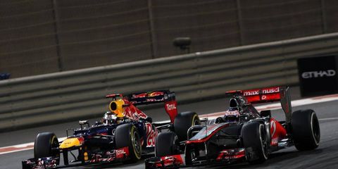 Jenson Button, right, was unable to hold off hard-charging Sebastian Vettel on Sunday in Abu Dhabi.