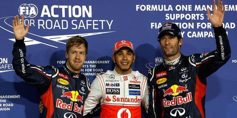 Pole sitter Lewis Hamilton is flanked by Sebastian Vettel, left, and Mark Webber as they celebrate their top-three qualifying efforts at Abu Dhabi on Saturday.