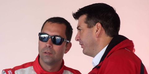 Starworks Motorsports owner Peter Baron, right, talks to driver Alex Popow at Daytona International Speedway during the 2013 Rolex 24 Hours at Daytona.