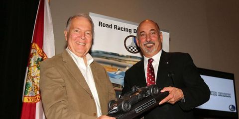 Peter Brock receives the Phil Hill Award from Road Racing Drivers Club president Bobby Rahal.